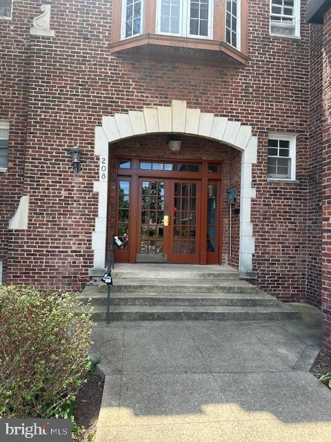 a view of a brick building with large windows