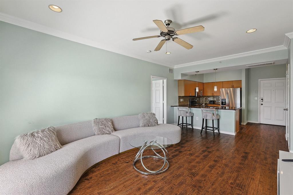 a living room with furniture and kitchen view