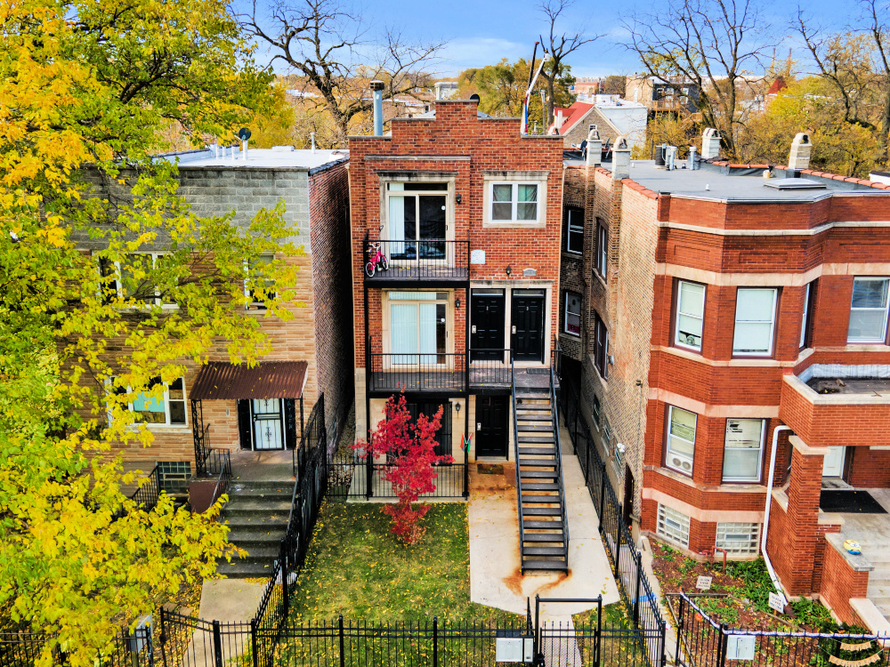 a front view of a multi story residential apartment building with yard