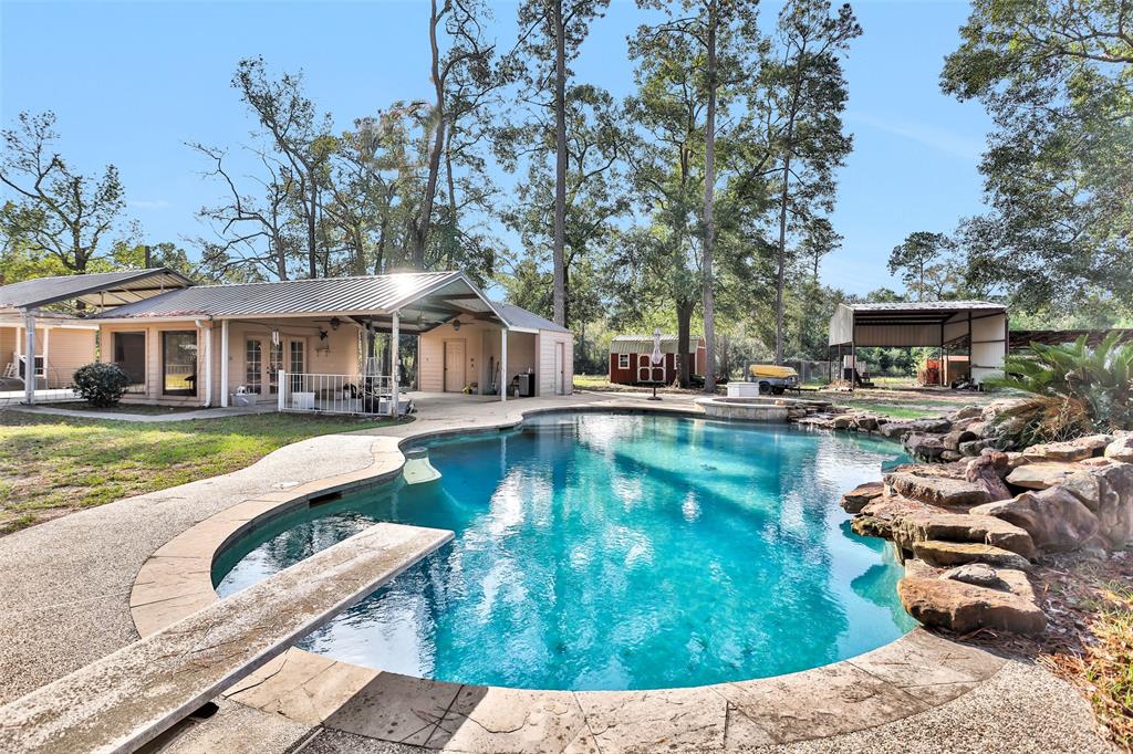 a view of a house with swimming pool and sitting area