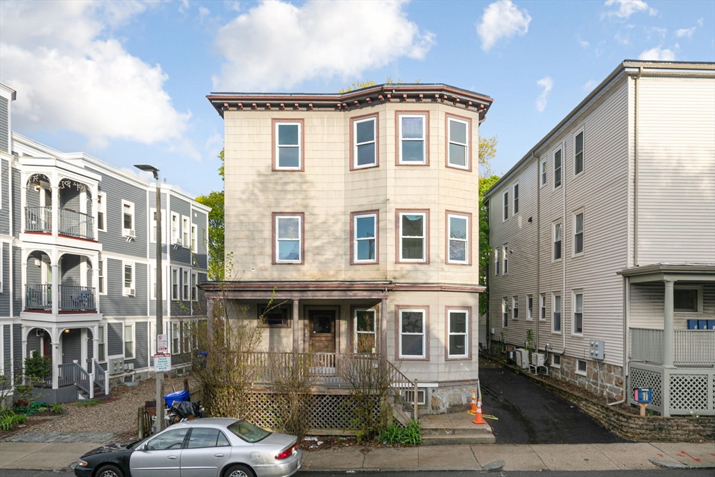 a front view of a residential apartment building with a yard