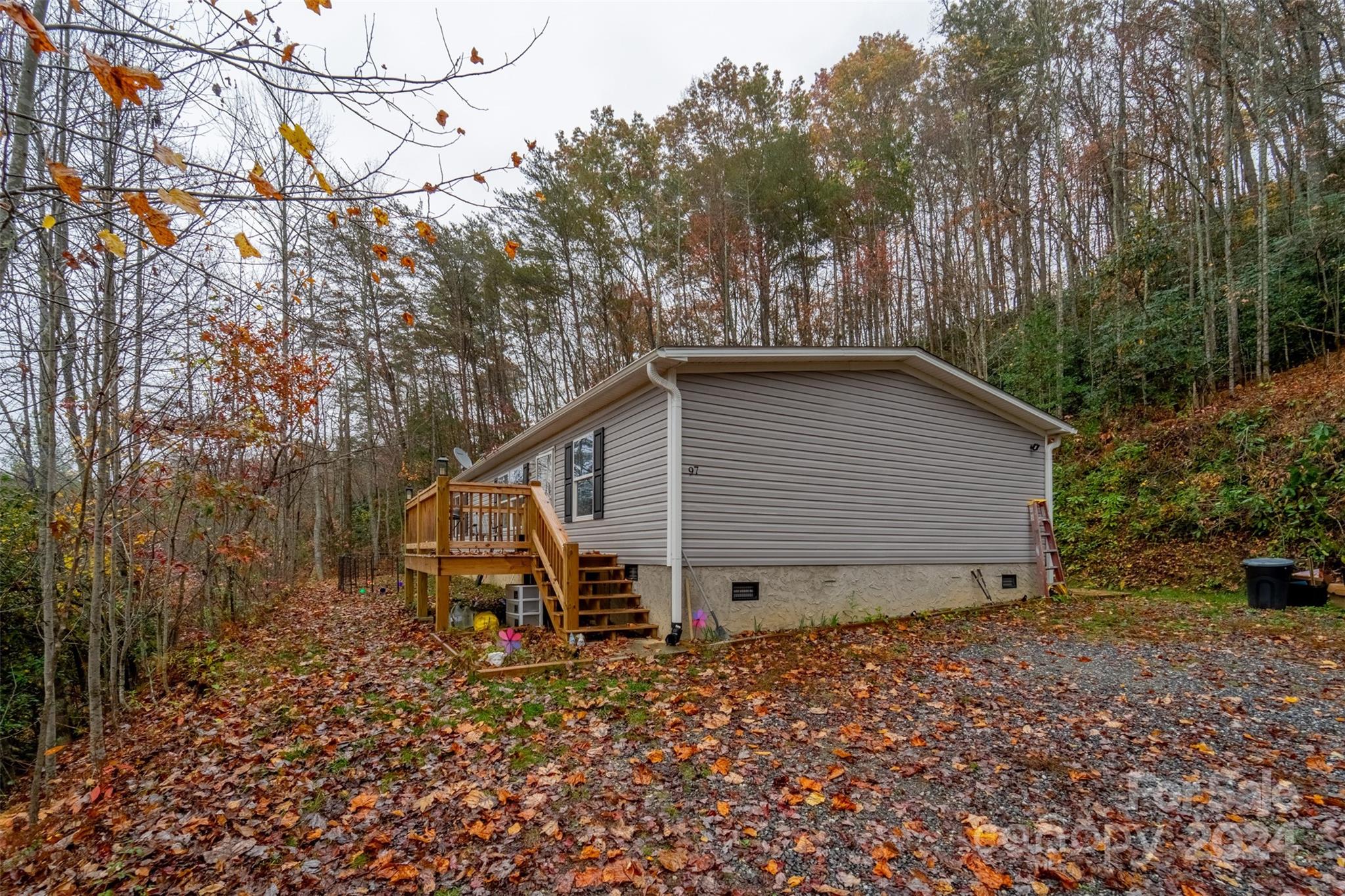 a view of a house with a yard and trees