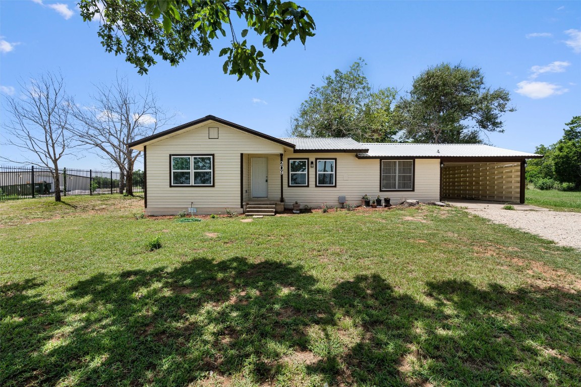 a front view of house with yard and green space