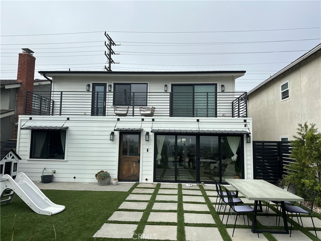 a view of a patio with table and chairs with wooden floor and fence