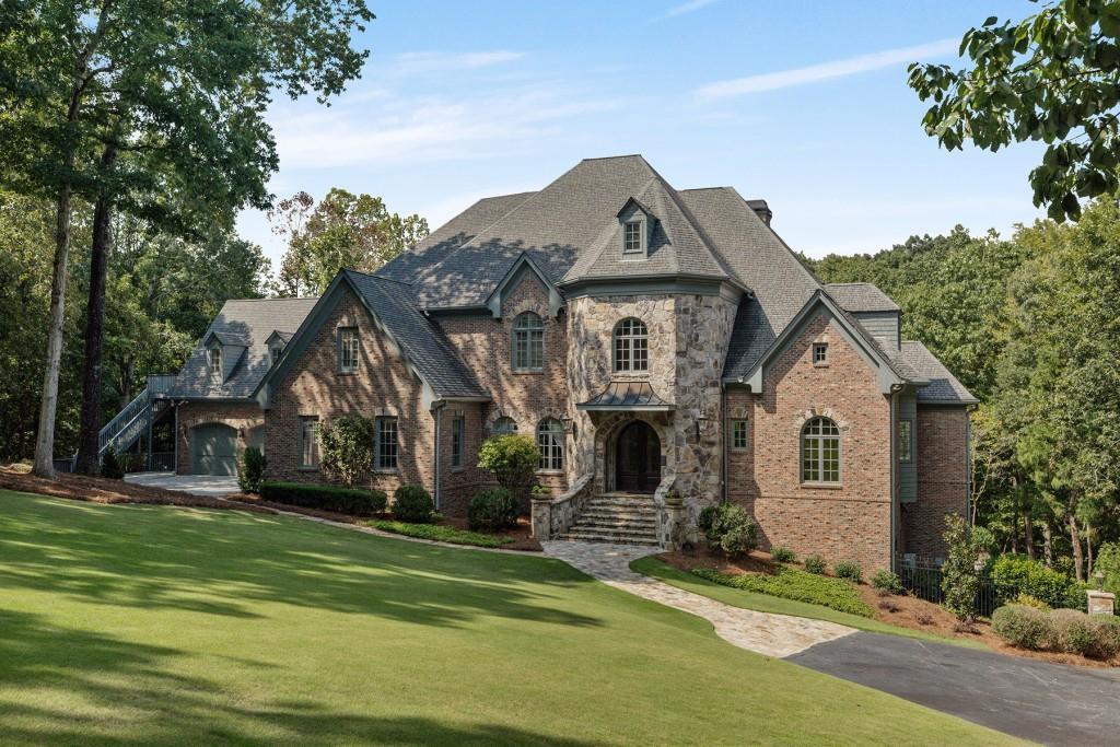 a front view of a house with a garden