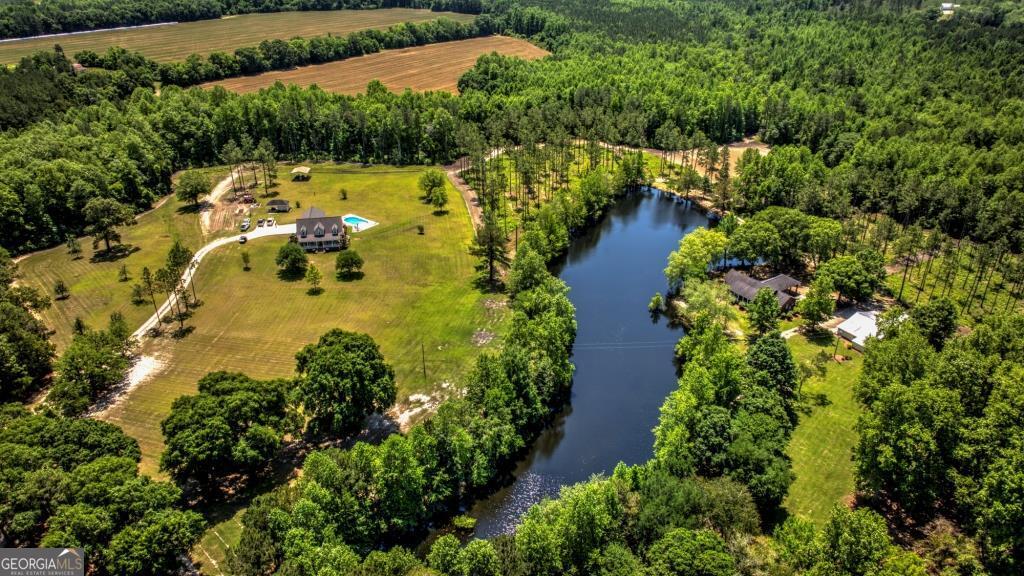 an aerial view of residential house with outdoor space and swimming pool