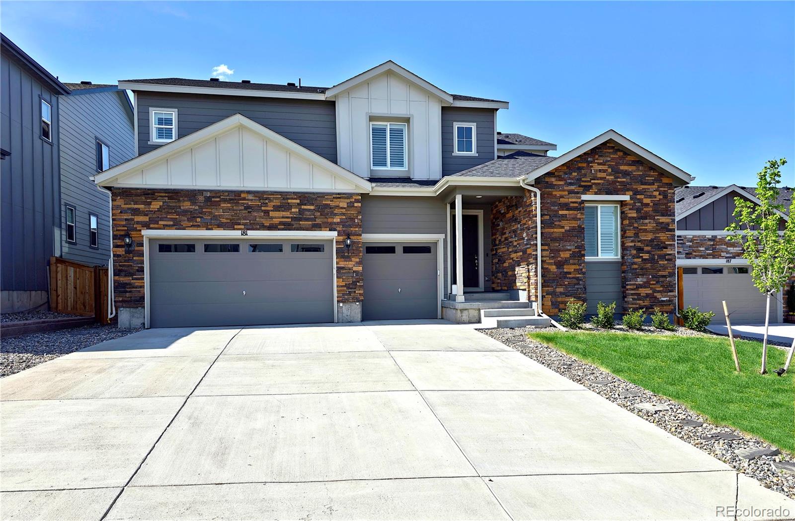 a front view of a house with a yard and garage