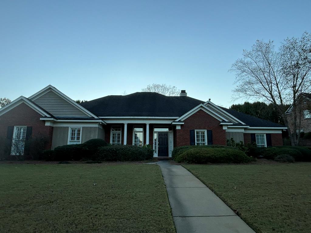 a front view of a house with a garden