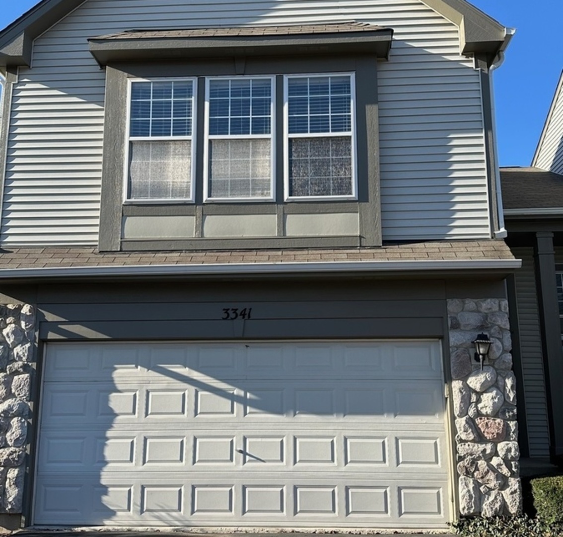 a view of a brick house with large windows