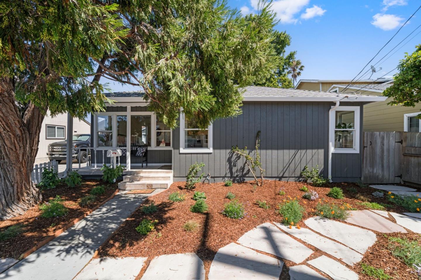 a view of house with backyard space and garden