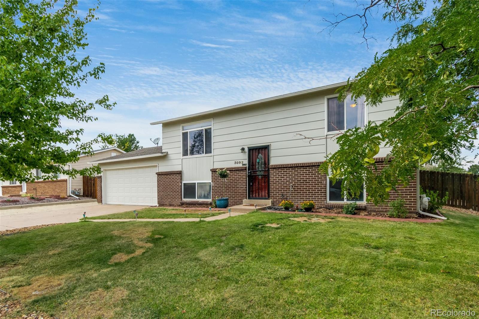 a house view with a sitting space and garden