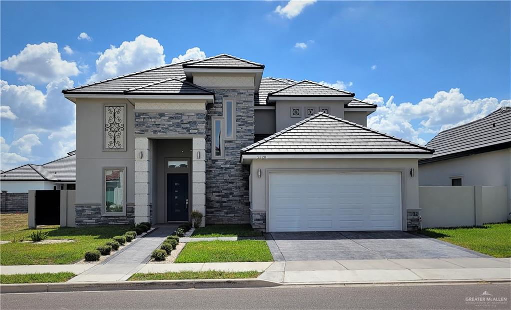 a view of a house with a yard and garage