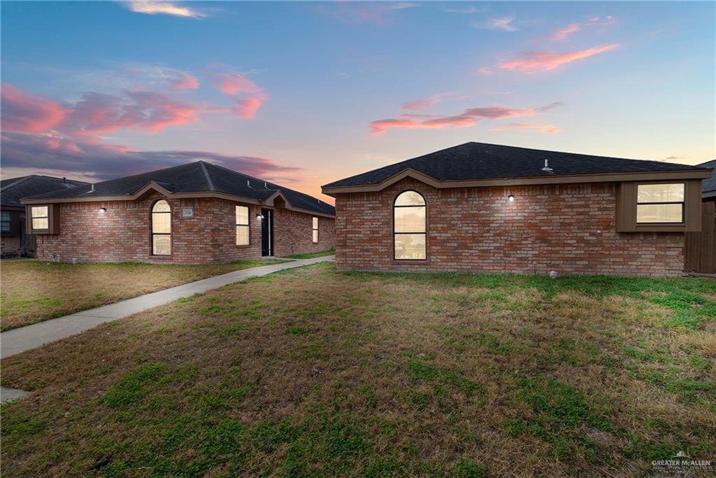 Ranch-style house featuring a lawn