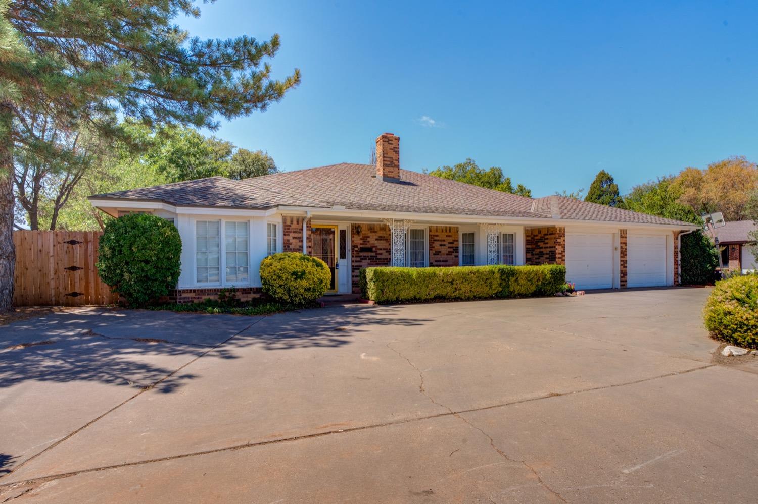 a front view of a house with a yard and a garage