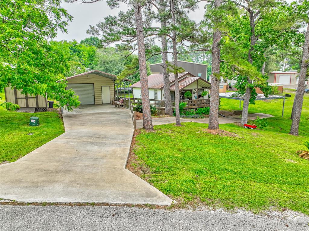 a front view of house with a garden and trees