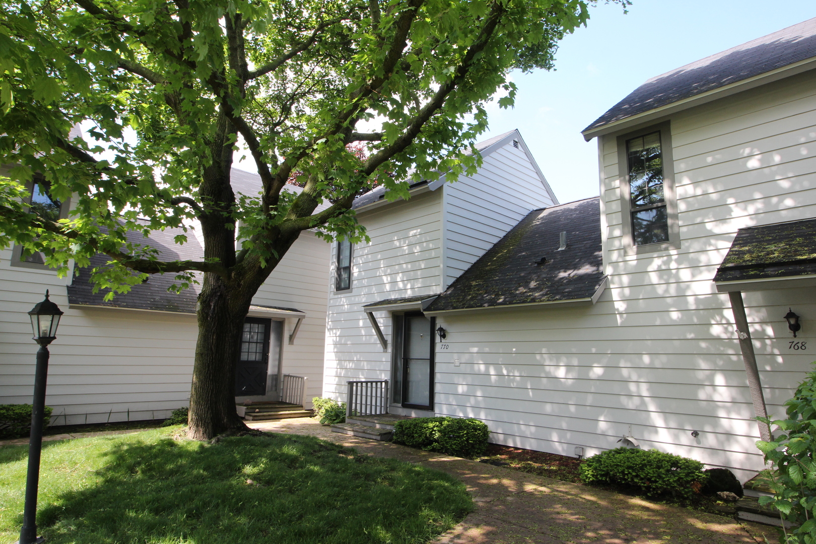 a front view of house with yard and outdoor seating