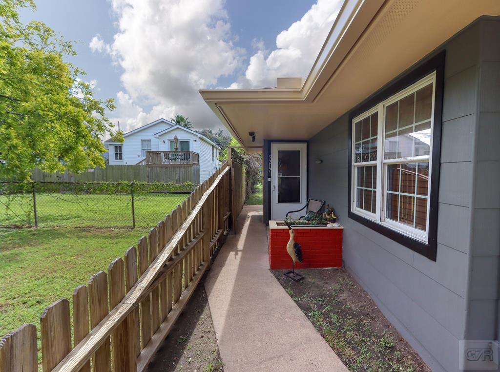 a balcony with wooden floor and garden