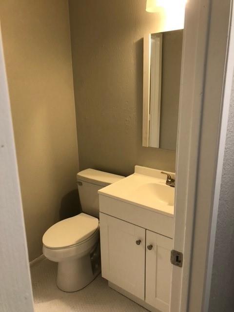 a white toilet sitting next to a bathroom sink