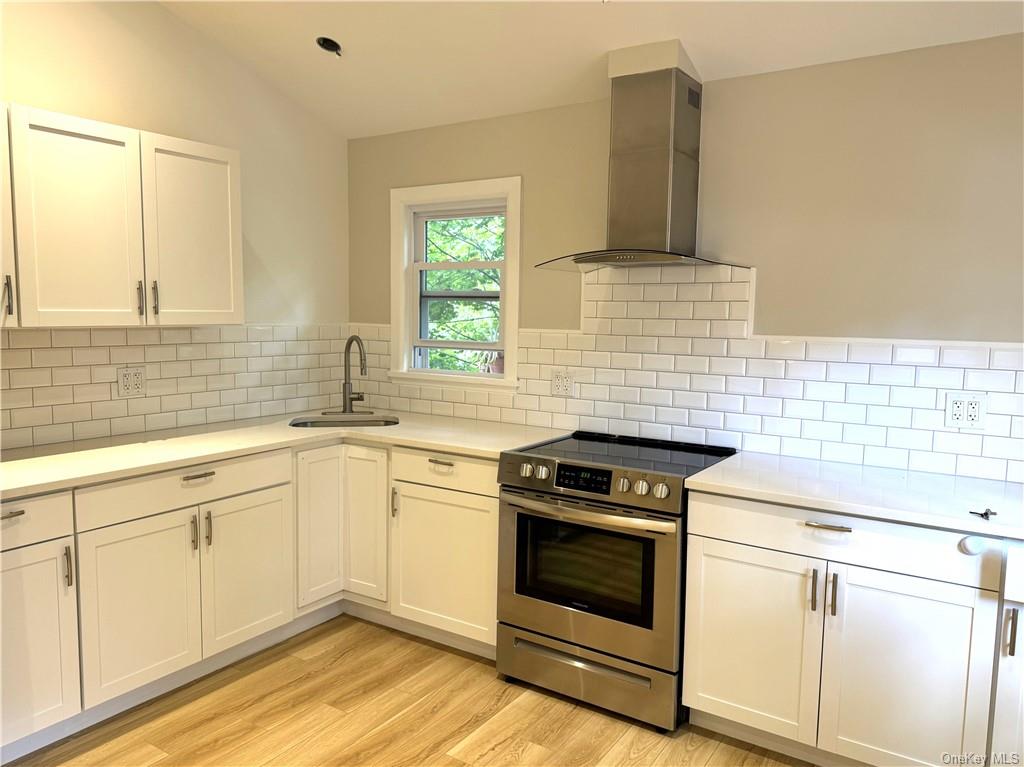 a kitchen with granite countertop cabinets stainless steel appliances and a sink