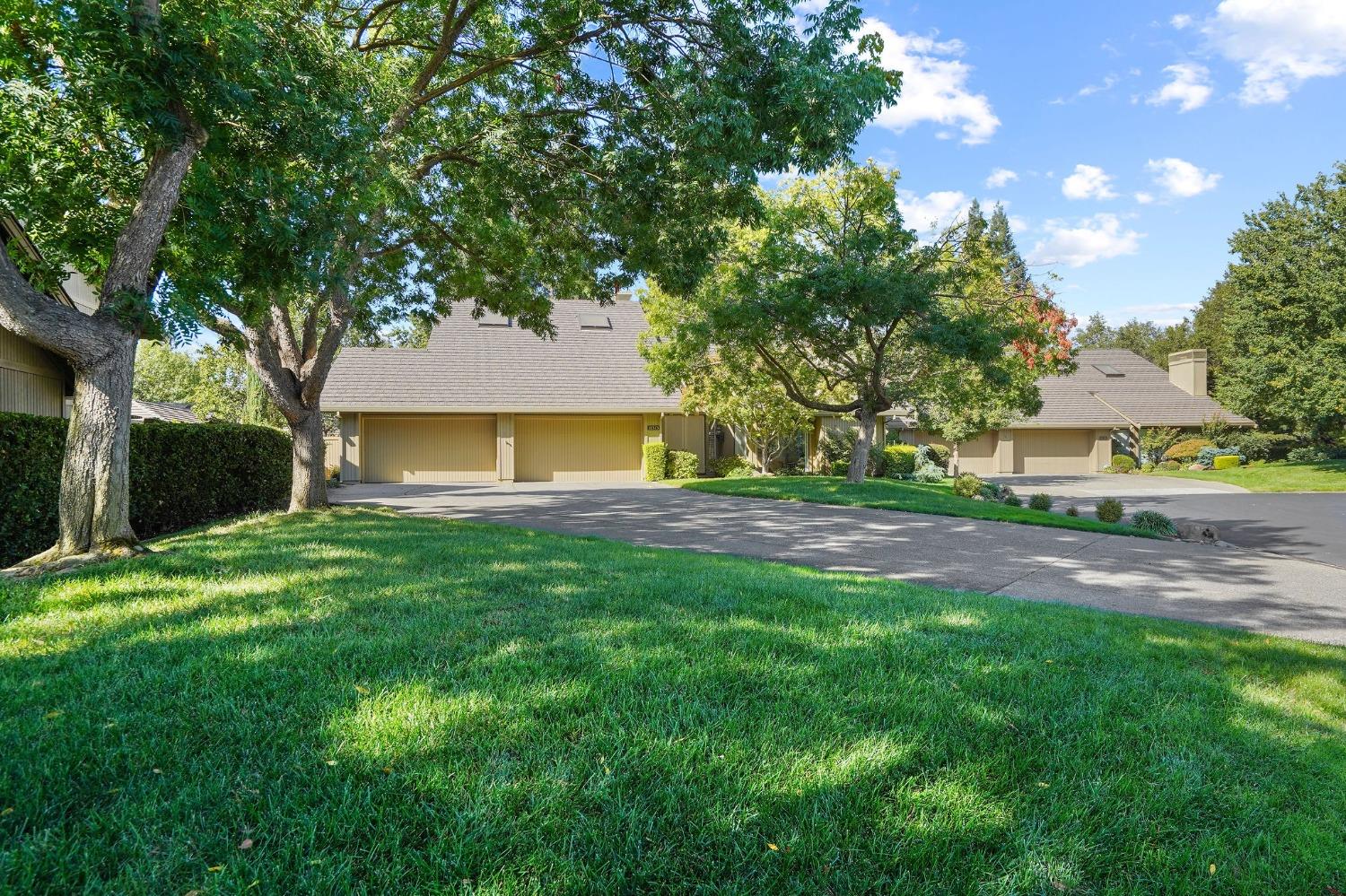 a front view of a house with a yard and a garage