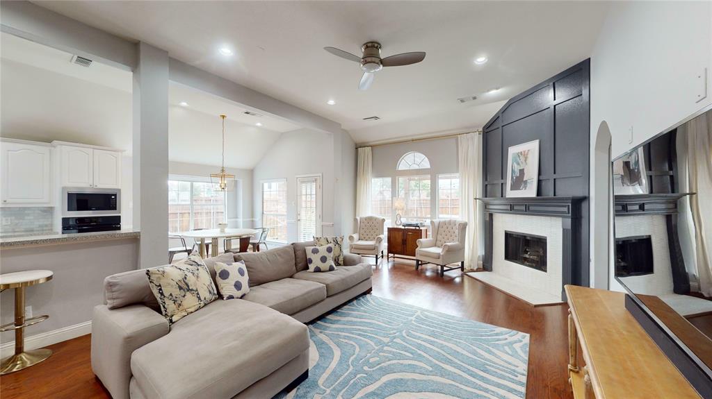 a living room with furniture fireplace and flat screen tv