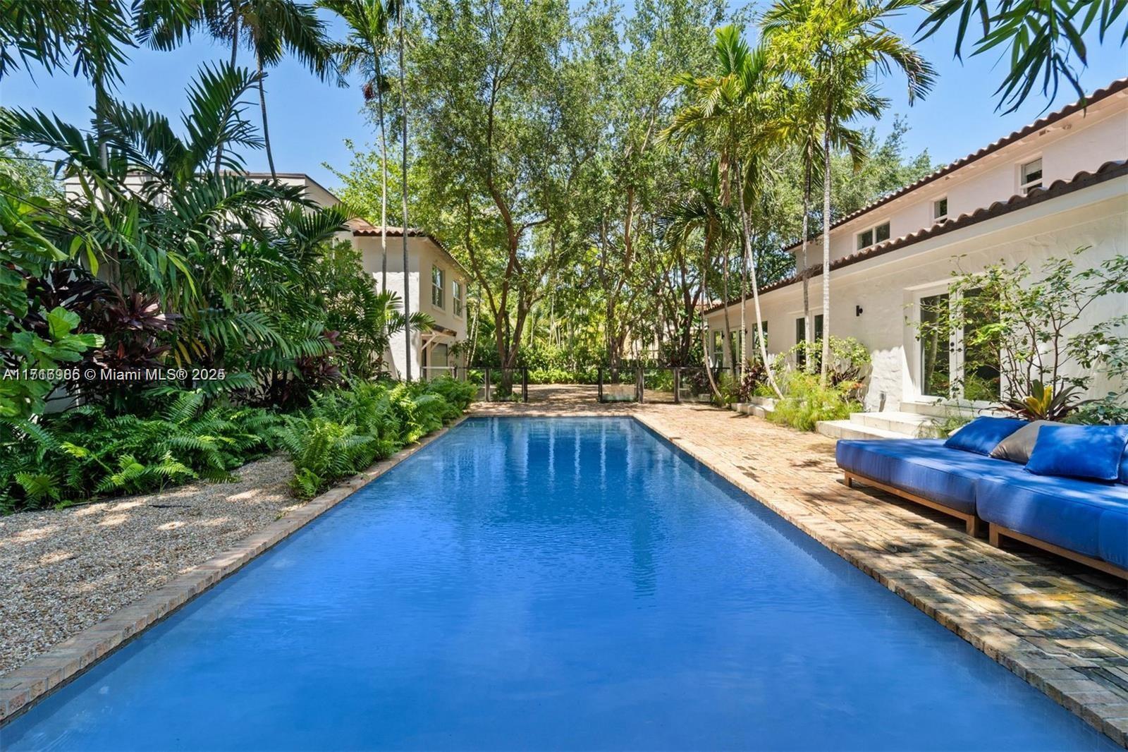 a view of swimming pool with outdoor seating and plants