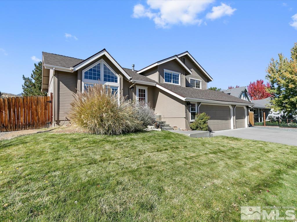 a front view of house with yard and green space