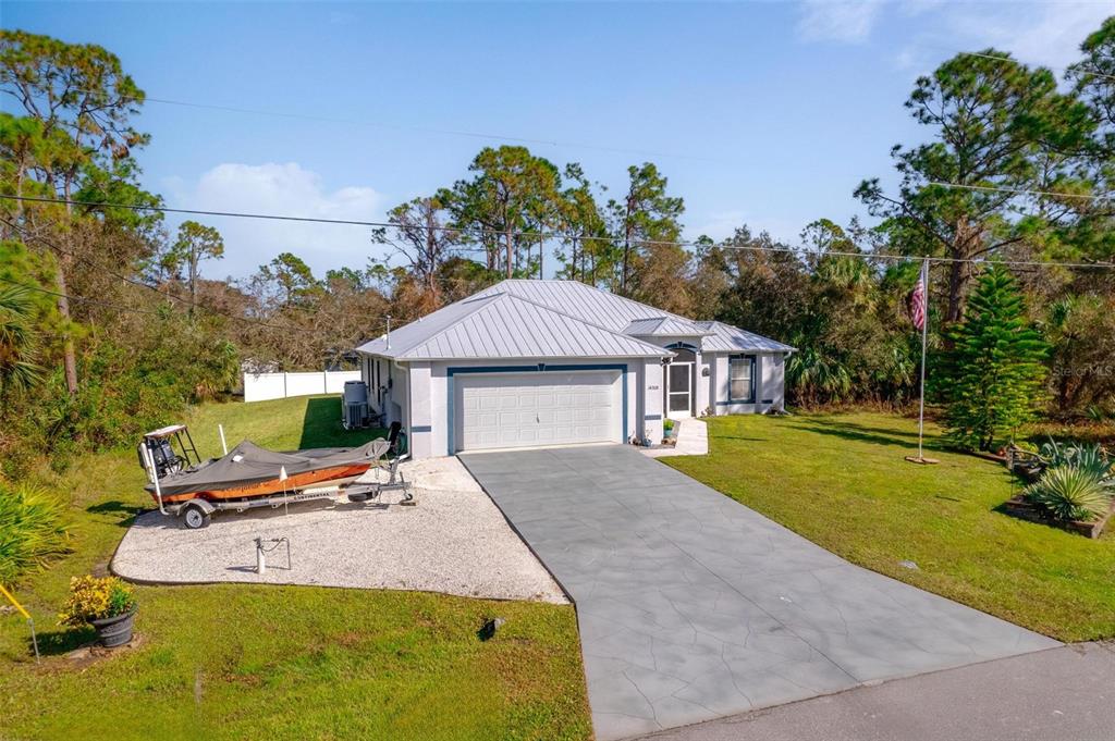 a view of a house with pool yard and outdoor seating