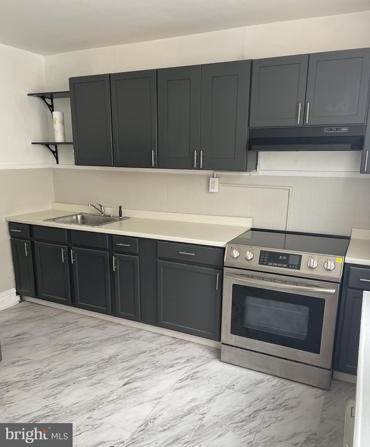 a kitchen with a sink and a stove