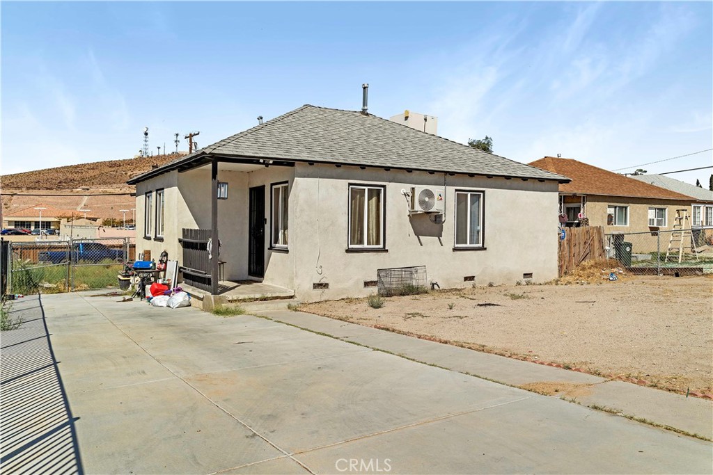 a view of a house with wooden fence