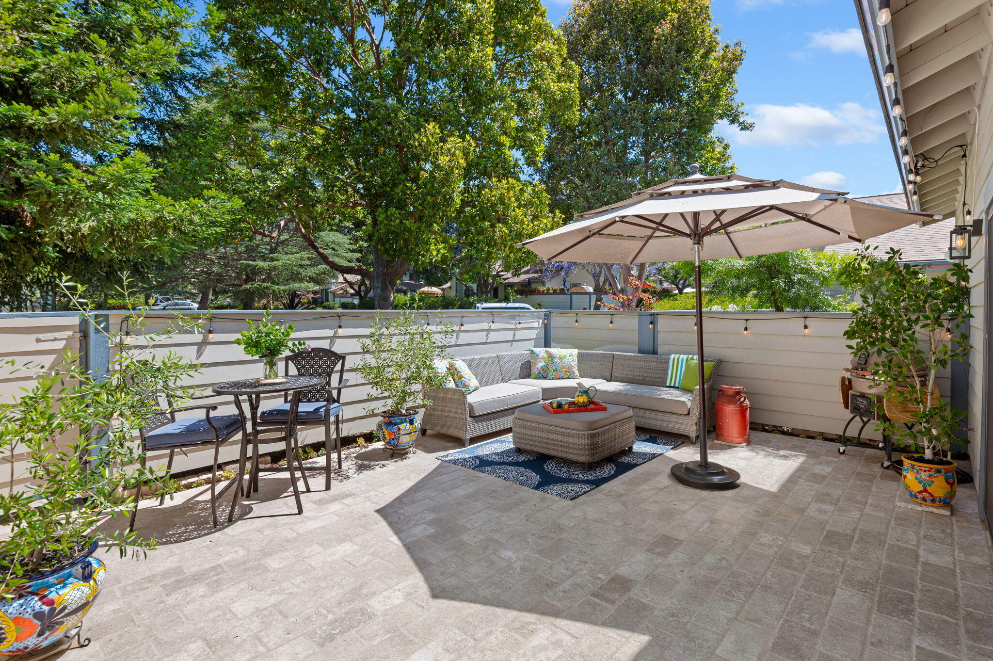 a view of backyard with outdoor seating and trees