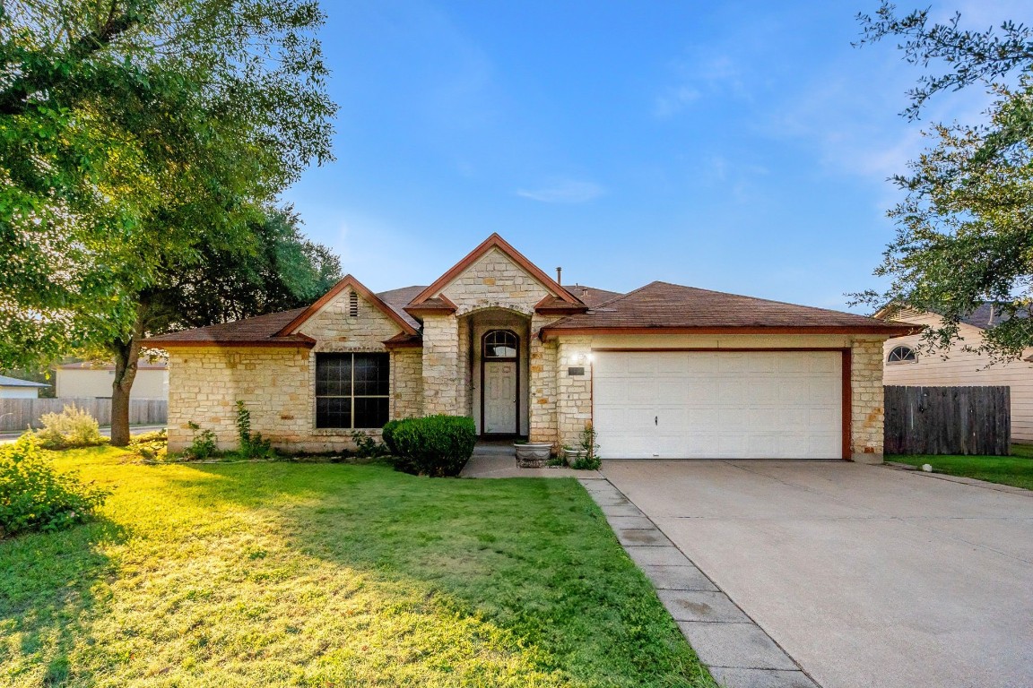 a front view of a house with a yard and garage