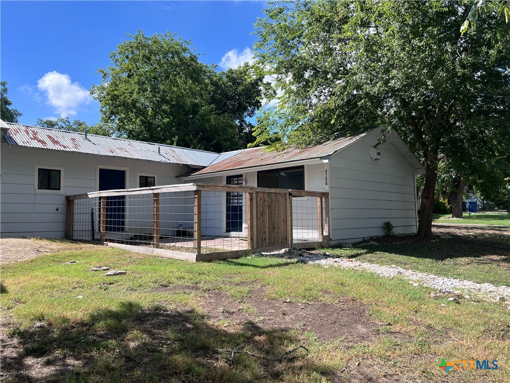 a backyard of a house with yard and garage