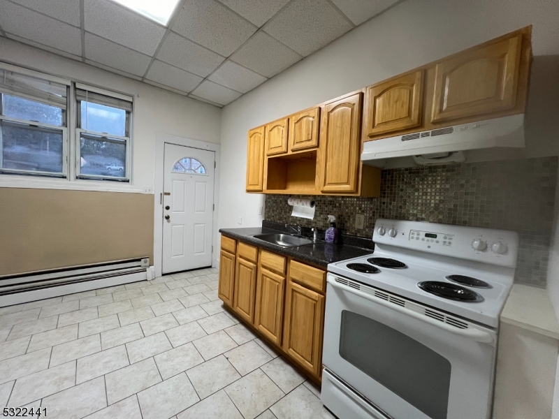 a kitchen with stainless steel appliances a stove a sink and a microwave