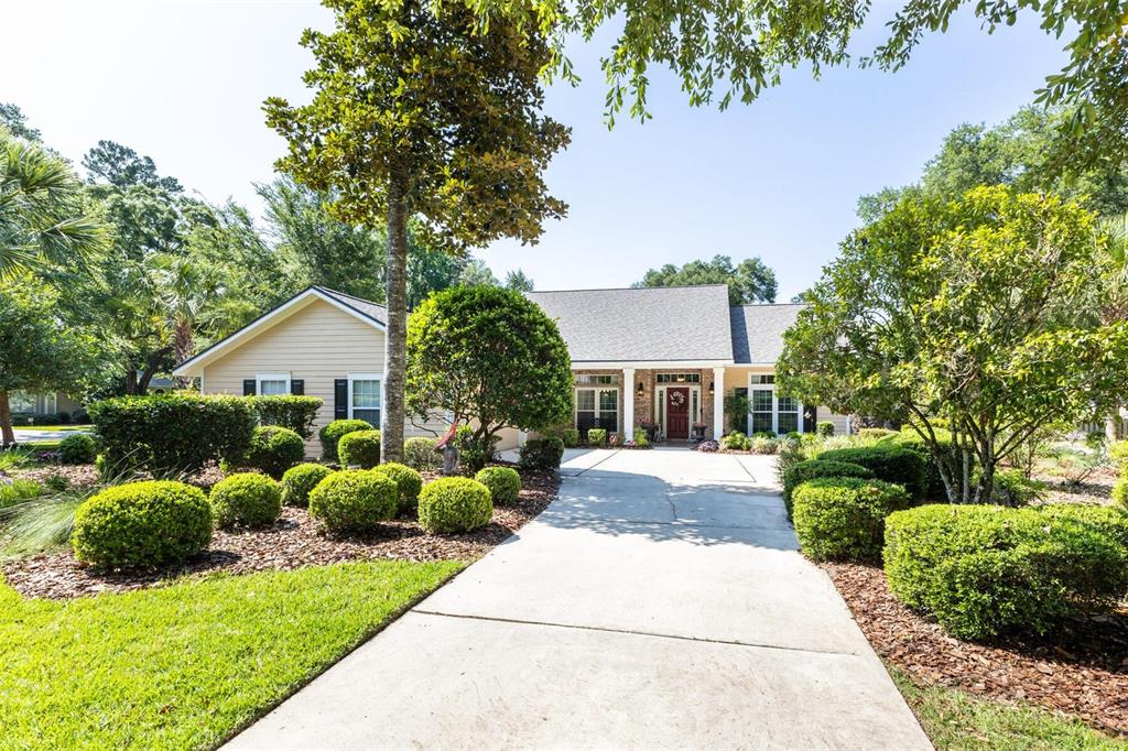 a front view of house with yard and green space