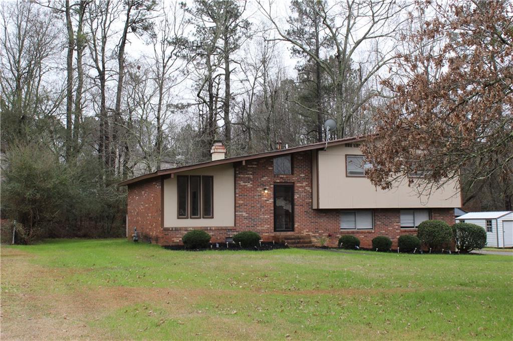 a front view of house with yard and trees