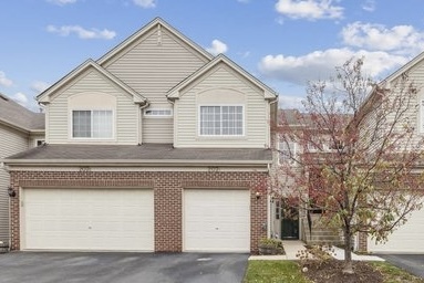 a view of a house with a yard and garage