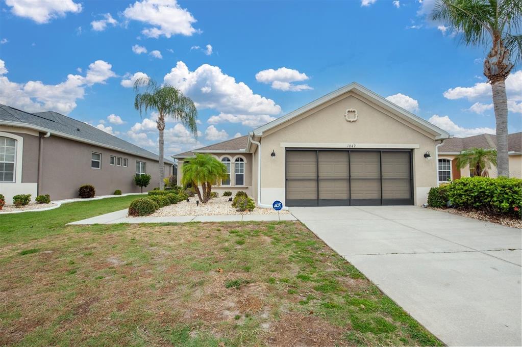 a front view of a house with a yard and garage