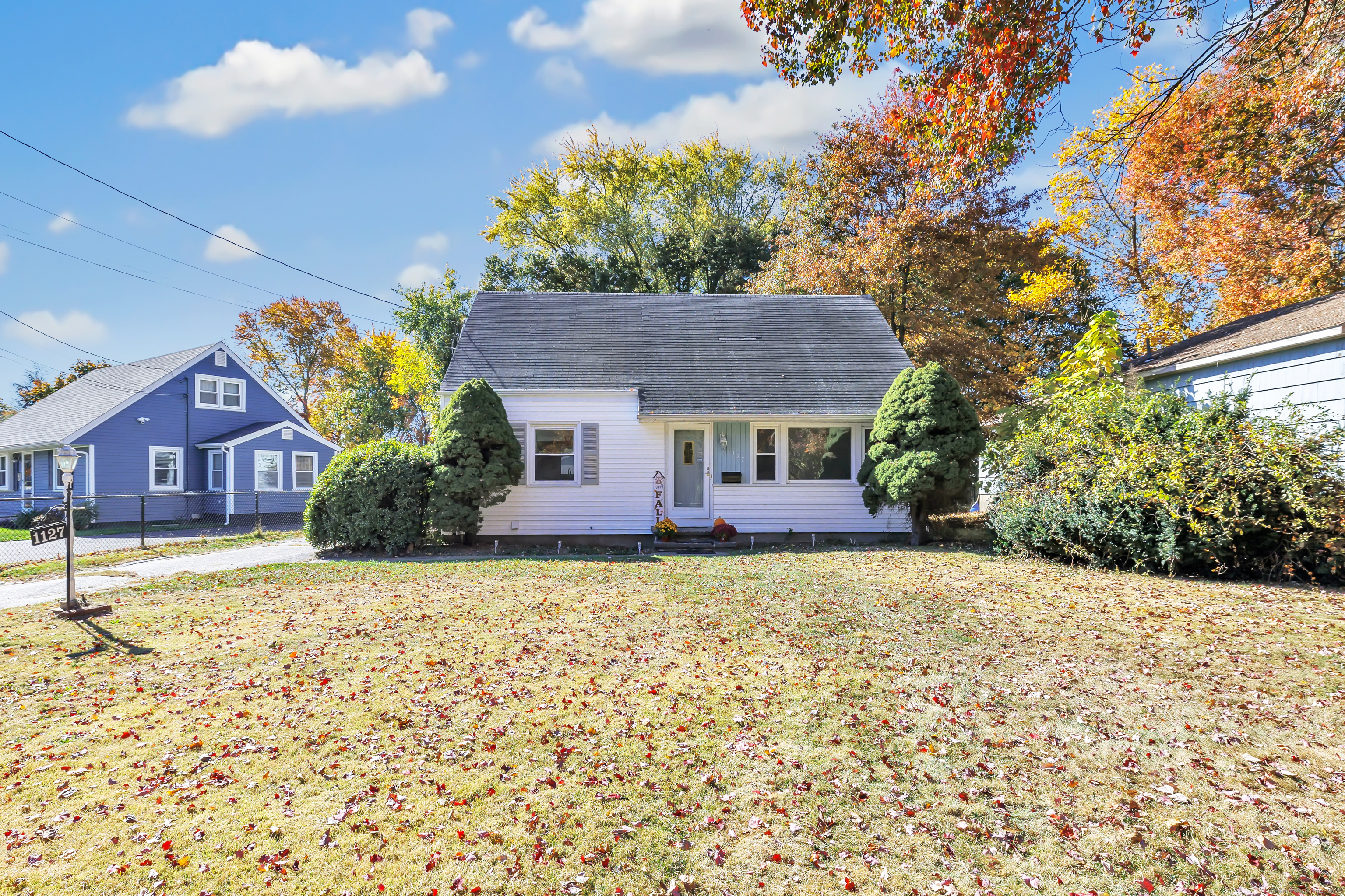 a front view of a house with a garden