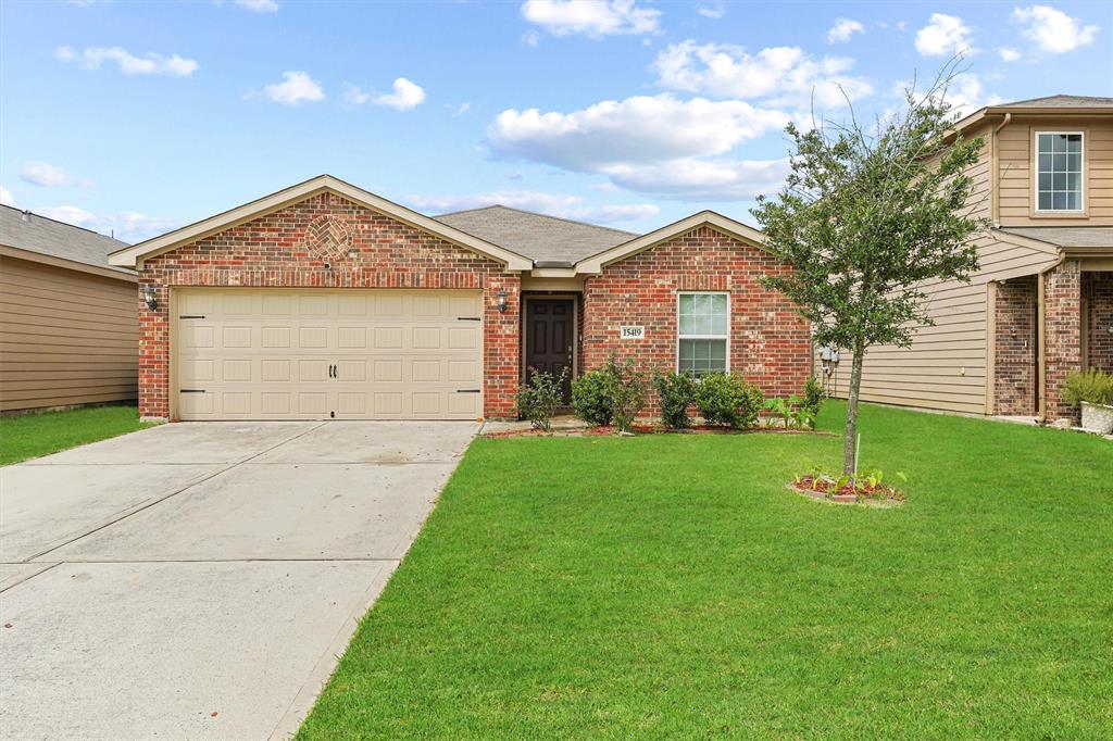 a front view of a house with a yard and garage