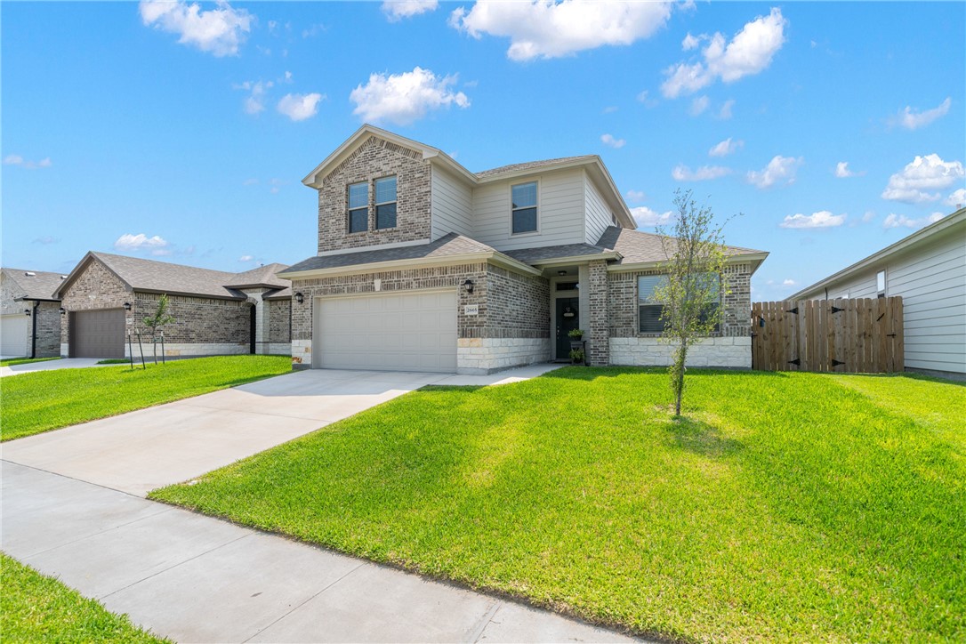 a front view of a house with a yard and garage