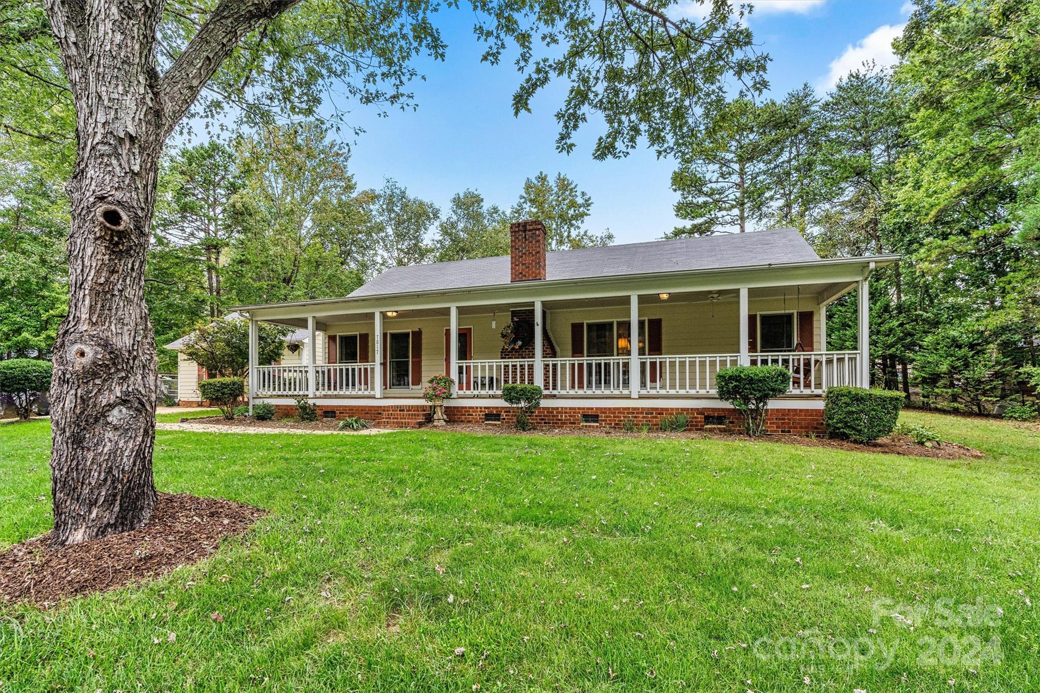 a front view of house with yard barbeque and outdoor seating