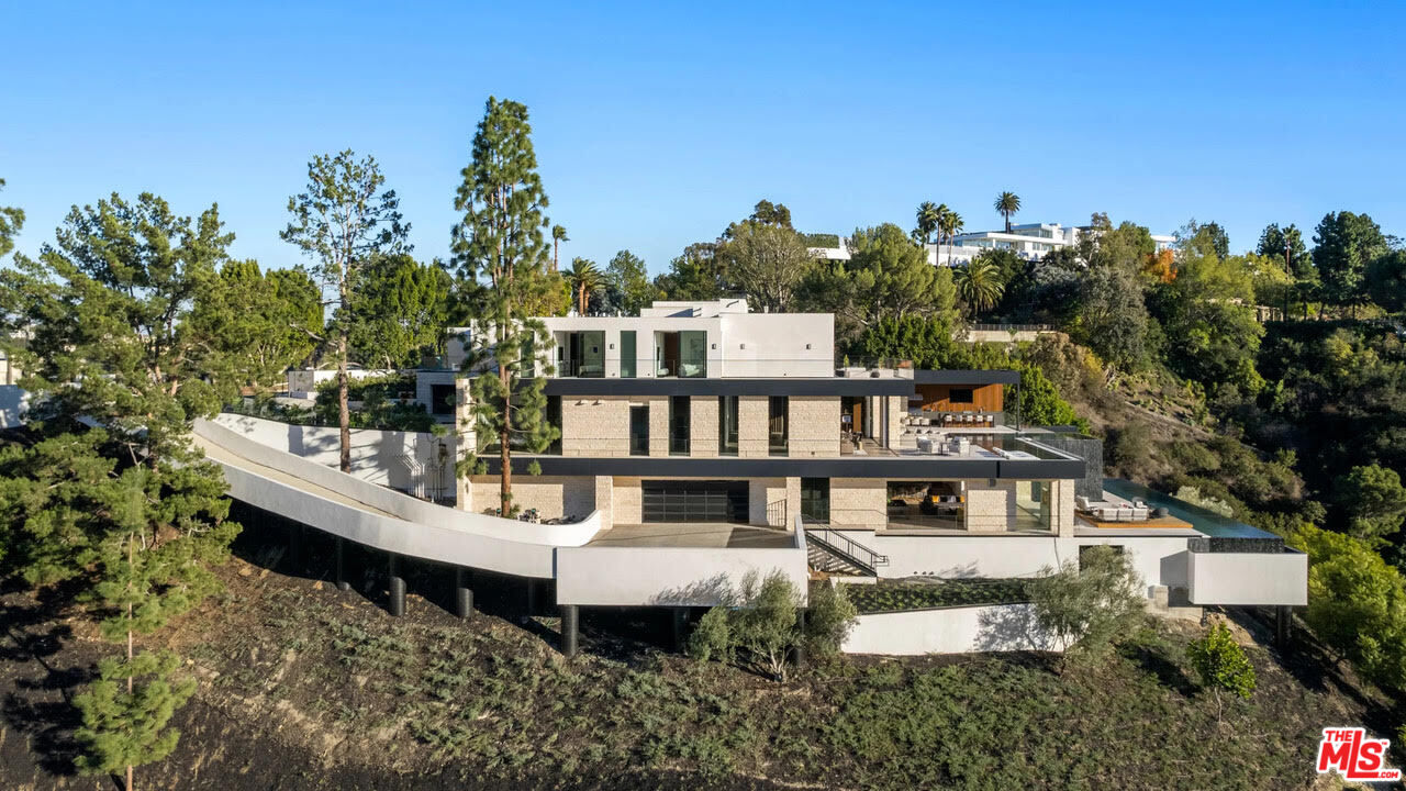 a view of a house with roof deck and sitting area