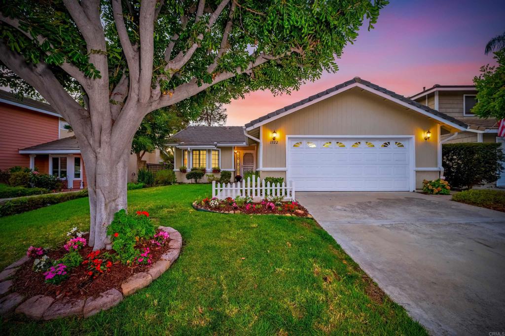 a front view of a house with a yard and fountain