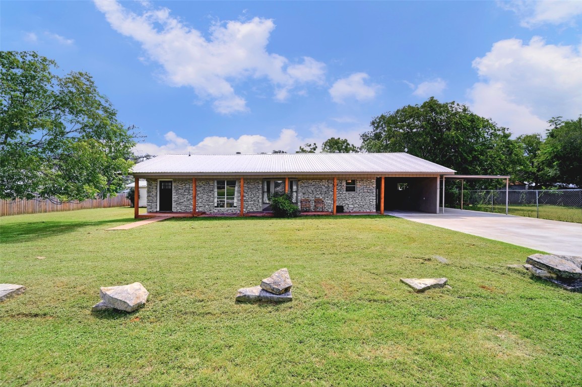 a front view of house with yard entertaining space and seating area