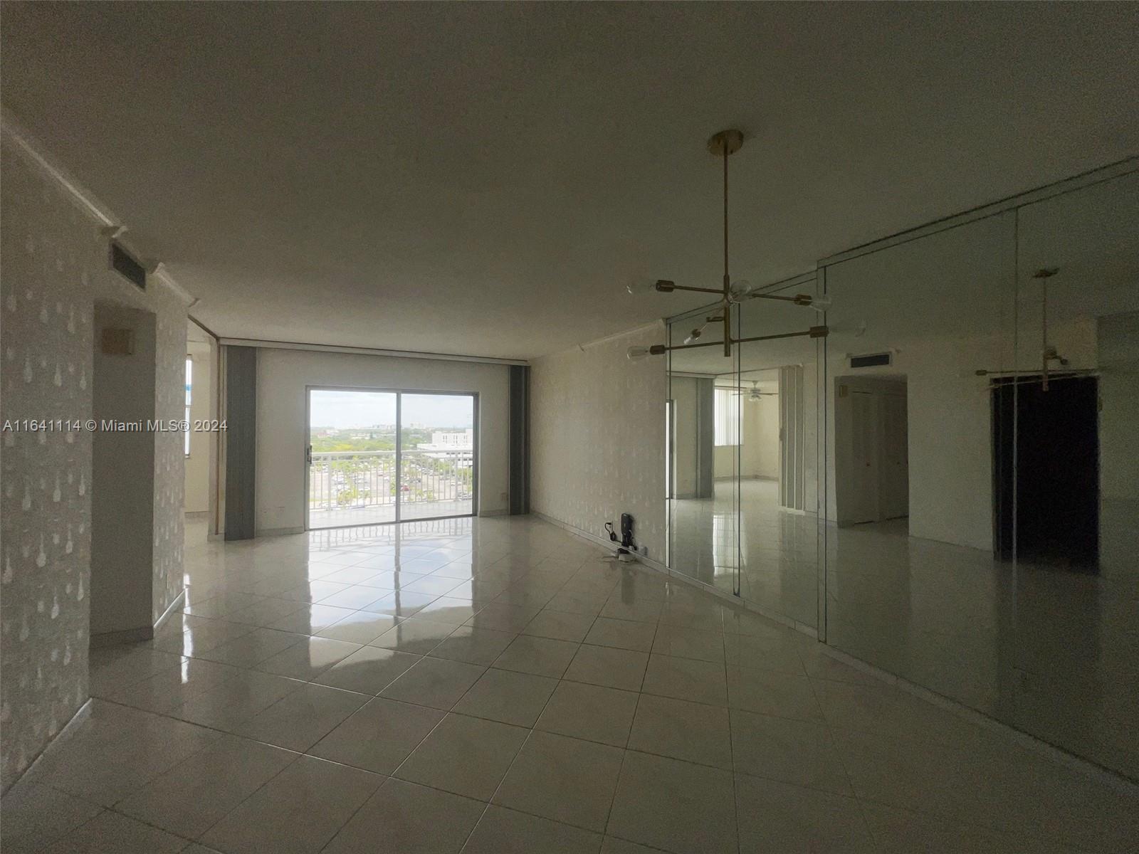 a room with natural light and kitchen view