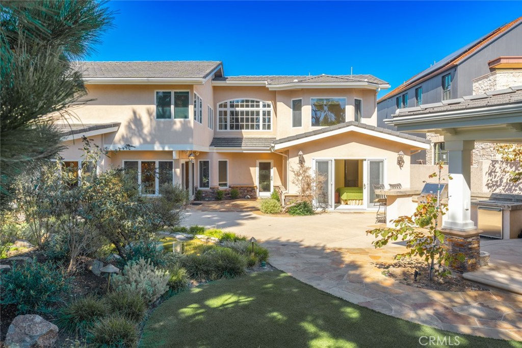 a front view of a house with swimming pool and porch