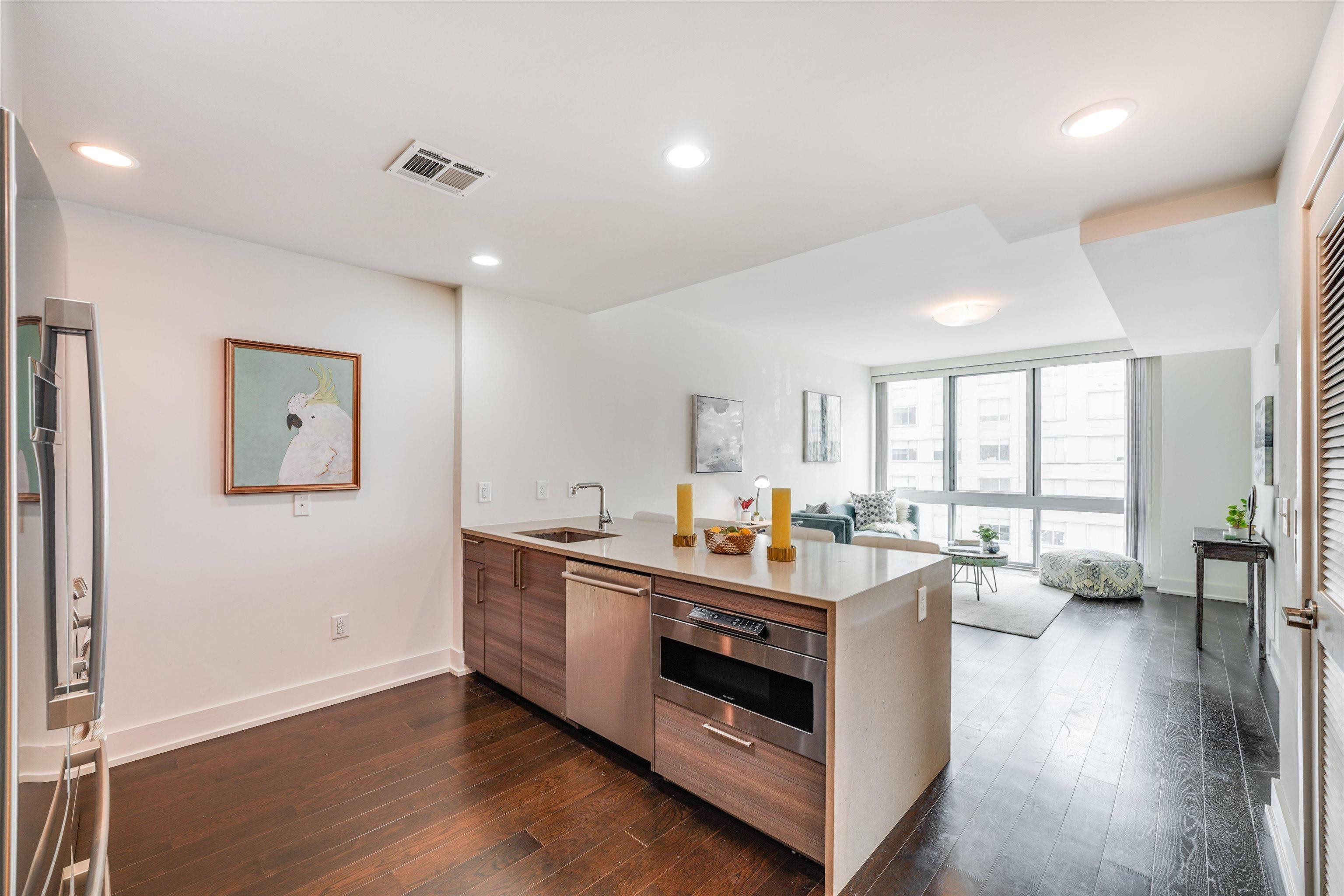 a view of a kitchen with furniture and wooden floor