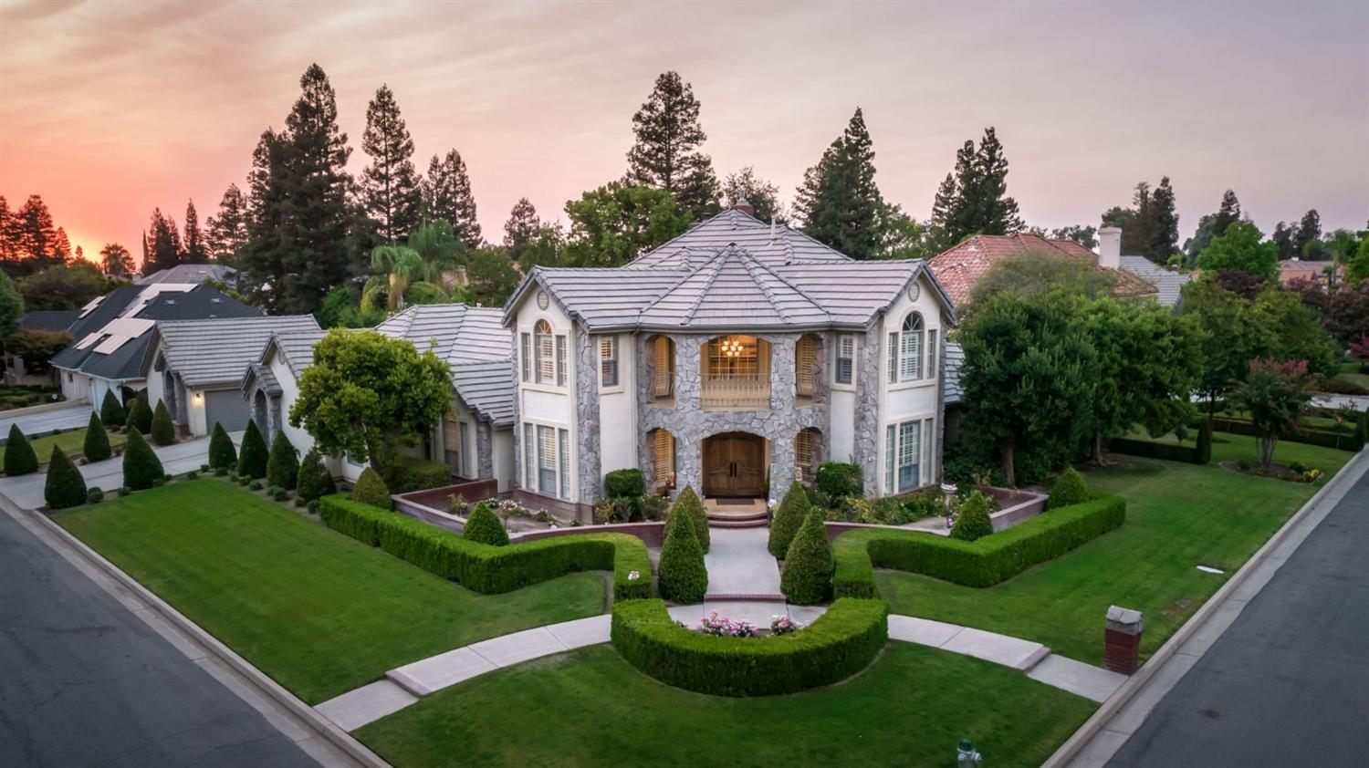 a front view of a house with a yard fire pit and outdoor seating