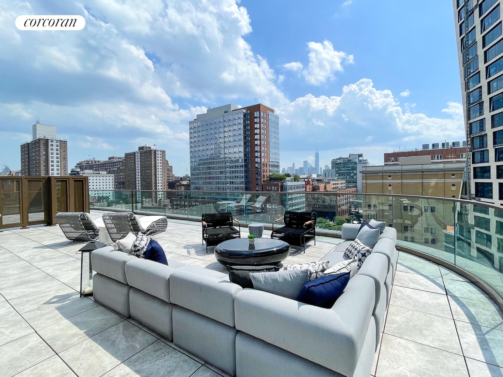 a view of a roof deck with couches and potted plants